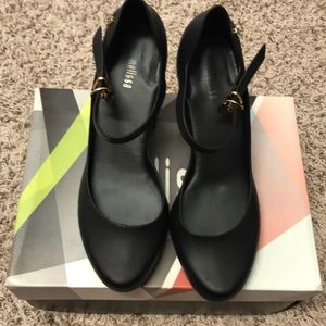 Black Melissa shoes with gold metallic heel